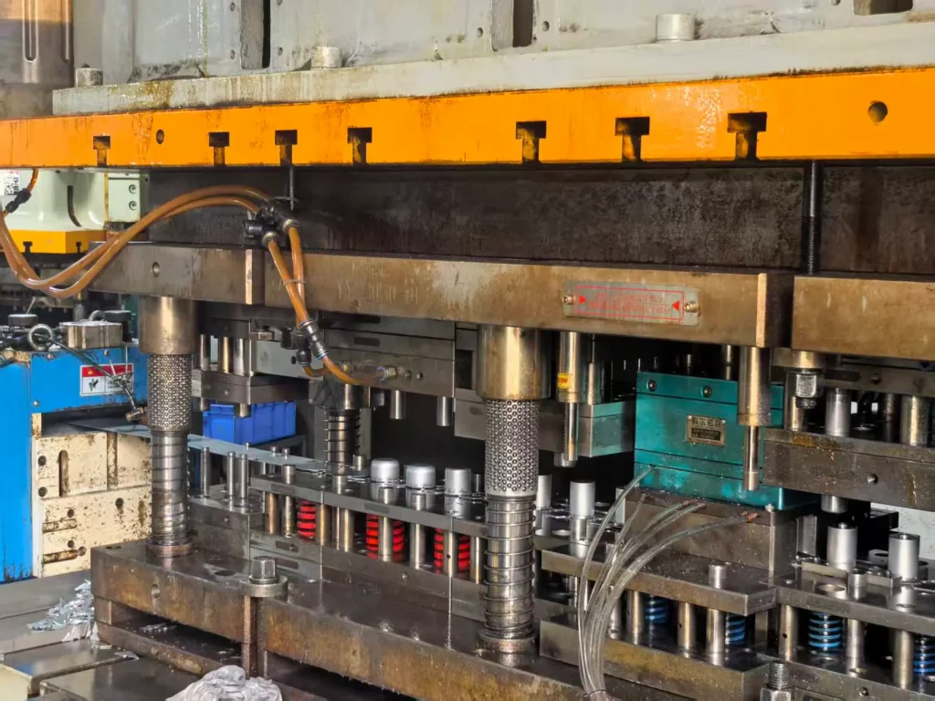 compound die stamping process in a precision metal stamping press