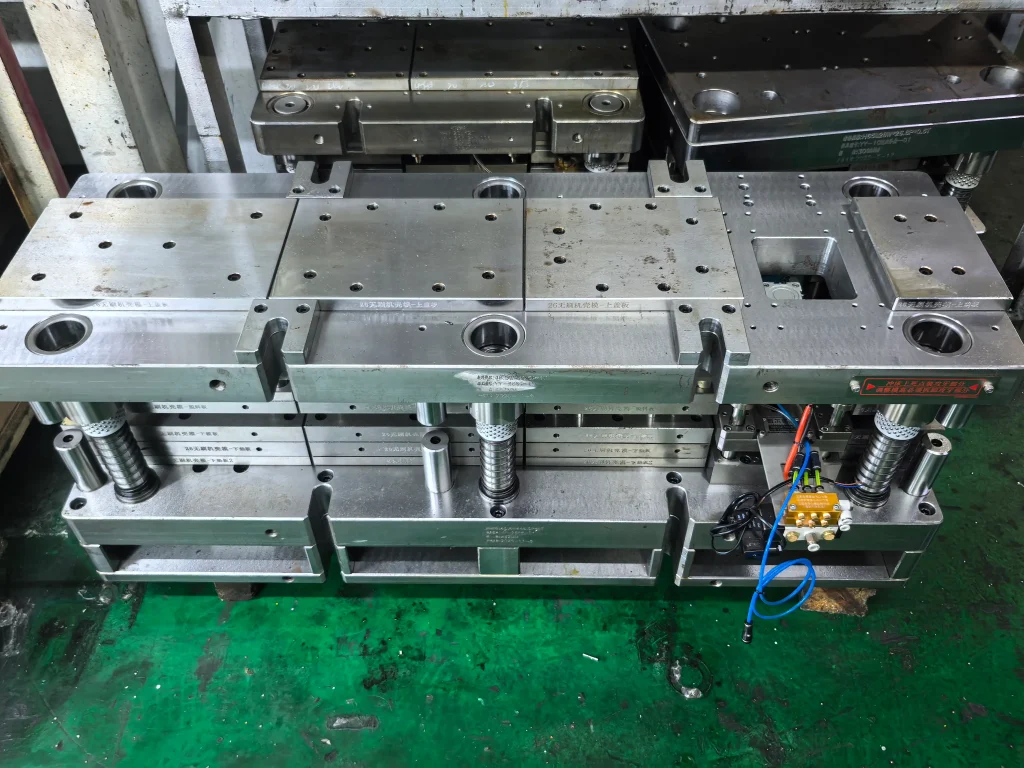 progressive die tooling in workshop for precision metal stamping